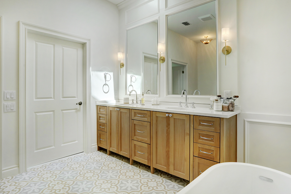 Colorado Crossing patterned floor tile extending beneath a double vanity